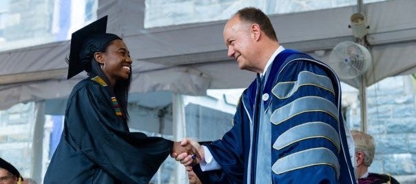 Our proud EPID graduate shakes hands with Georgetown President John DeGioia on commencement day